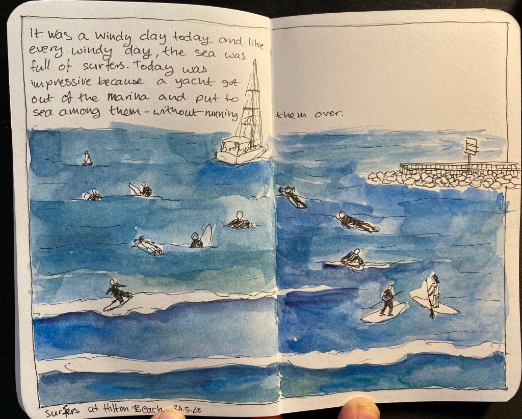 A sketch of surfers and a yacht in the sea, enclosed in a drawn frame and with a bit of text describing the scene on the top left corner.